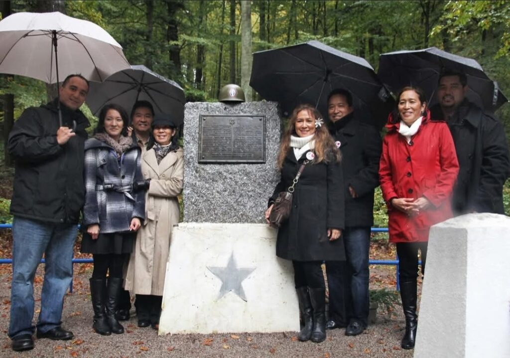 Kristen Nemoto Jay with Susan Harada and five other at Bruyères, Lorraine, France at the American Monument in the Helledraye Forest. (Photo courtesey of Kristen Nemoto Jay)
